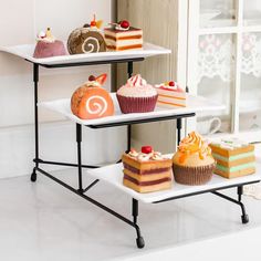 three tiered trays holding cakes and cupcakes