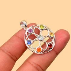 This 7 gemstone Chakra pendant with silver is a great way to add more energy for prosperity, peace, balance, and happiness! The silver provides grounding and also protects the wearer from external influences. The gemstones represent our seven main chakra, seen as the centers of our being. Each of these chakra is responsible for different actions or releases them. Average Weight - 6.2 gm We Assure Your Satisfaction With Our High-Quality Jewelry * Sterling Silver * Natural Gemstone * Nickel free * Made in India With Love And High Standards Our products are totally handmade and made with high quality gemstones and 925 solid sterling silver. If you believe in buying top quality products for yourself and for your family and friends,  RCjewell is the place where you want to be There are unique p Shanku Chakra Design Gold Pendants, Chakra Jewelry Necklaces, Spiritual Sterling Silver Round Pendant Gemstone, Throat Chakra Jewelry, Chakra Pendant, Luck Charms, Healing Jewelry, Silver Plated Jewelry, Personalized Necklace