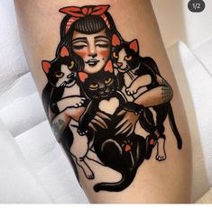 a woman with two cats on her leg and one cat sitting on the other arm