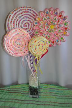 a vase filled with lollipops on top of a table