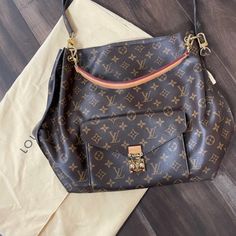 Authentic Louis Vuitton Mtis Hobo Bag Retired Mint Condition. Large Spacious Interior With Extra Large Zippered Pocket. Two Open Flat Pockets Inside As Well. Beautiful Soft Brown Lining. Front Exterior Pocket Has Functional Mechanical Lock. It Is Large Enough To Fit The Iphone 13 Pro Max. Two Carry Handles Which Are Easily Detachable. The Monogram Canvas Handle Is Adjustable. Both Allow For On-Shoulder Or Arm Style Carrying.. Comes With Original Dust Bag. In Excellent Used Condition.. Little If Lock It, Soft Brown, Iphone 13 Pro, Monogram Canvas, Hobo Bag, Authentic Louis Vuitton, Mint Condition, Inside Pocket, Louis Vuitton Bag