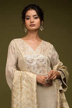 Ivory and beige kurta with cutdana embroidered floral jaal patterns embellished by mirrorwork. Comes with flared pant, inner and dupatta. - Aza Fashions Elegant V-neck Kurta For Festive Occasions, Beige Palazzo Set With Resham Embroidery For Reception, Elegant Beige Traditional Wear With Zari Work, Festive Beige Palazzo Set With Intricate Embroidery, Elegant Cotton Silk Palazzo Set With Chikankari Embroidery, V-neck Salwar Kameez With Dabka Work For Wedding, Elegant Beige Palazzo Set With Intricate Embroidery, V-neck Salwar Kameez For Wedding And Eid, Festive Palazzo Set With V-neck For Wedding