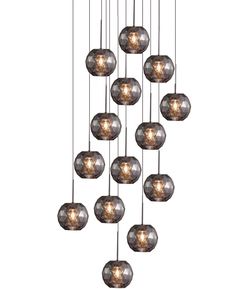 a chandelier with many glass balls hanging from it's sides and the lights on