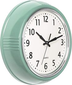 a mint green wall clock with black hands