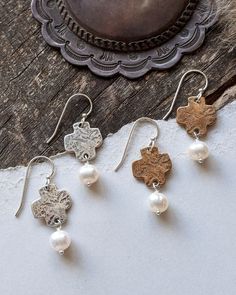 Inspired by the wild mountain tops. Where the most rugged rocks collide with the soft white clouds, creating a breathtaking view that only a few will ever see. We designed these easy to wear earrings to go with everything so that you can show your confident and feminine style all day, every day. Materials: sterling silver, ancient bronze, freshwater pearls (ear wires are sterling silver) Length: 1 1/4 inches White Hammered Sterling Silver Earrings, White Clouds, Cross Earrings, Mountain Top, Pearl Drop, Soft White, Breathtaking Views, Feminine Style, Ear Wires