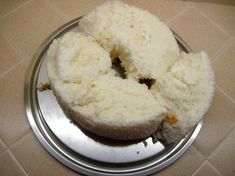 two pieces of cake sitting on top of a metal plate in front of a tile floor