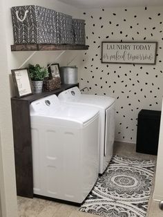 a white washer and dryer sitting next to each other in a laundry room