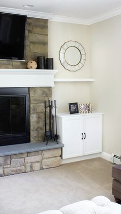 a living room filled with furniture and a flat screen tv mounted above a fire place