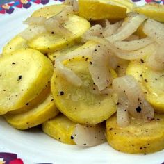 a white plate topped with sliced up bananas on top of a colorful tablecloth covered table