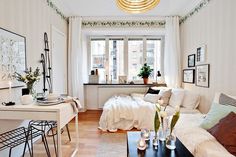 a living room filled with furniture and lots of white stuff on top of a hard wood floor