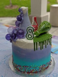 a birthday cake with frosting and decorations on the top is sitting on a table