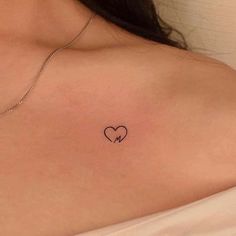 a woman with a heart tattoo on her chest