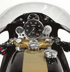 a close up of a motorcycle with a speedometer on the handlebars and gauges