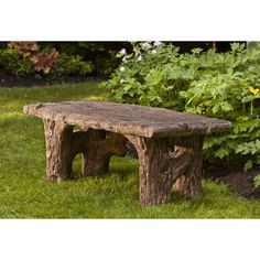 a stone bench sitting in the middle of a garden