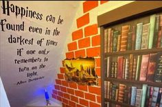 there is a book shelf with many books on it in the corner and a sign that says happiness can be found even in the darkest of times if one