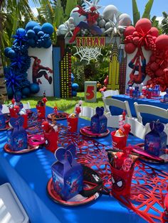 the table is set up with spiderman decorations