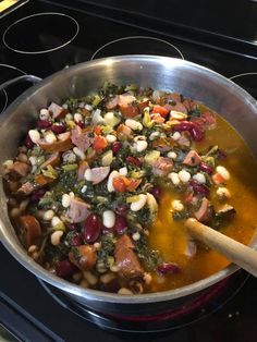 a pot filled with soup sitting on top of a stove