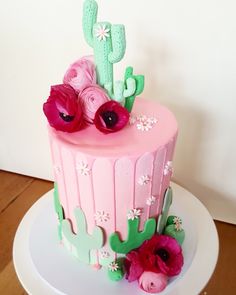 a pink and green cake with flowers on the top is for someone's birthday