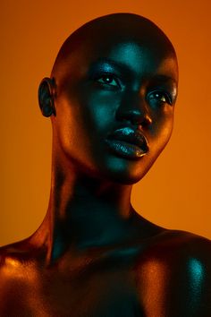 an image of a woman with black makeup on her face and neck, looking at the camera