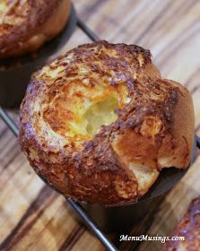 three muffins sitting on top of a metal rack