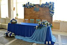 a table with blue cloth and flowers on it