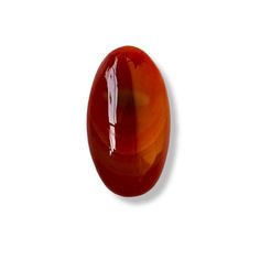 an oval shaped red glass object on a white background