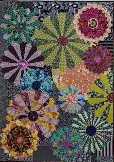 a quilt with many different colored flowers on it