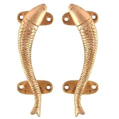 two gold fish shaped door handles on white background