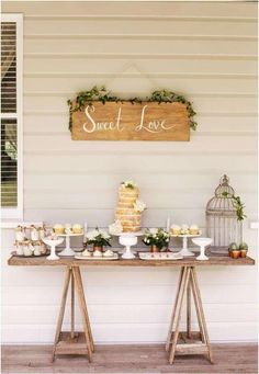 a table topped with cakes and cupcakes next to a sign that says sweet love