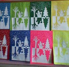 several different types of christmas cards on a shelf in front of a wall with trees and snowflakes