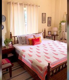 a bedroom with a bed, chair and pictures on the wall