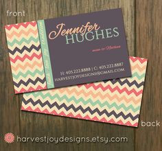 two business cards sitting on top of each other next to a wooden background with the words,