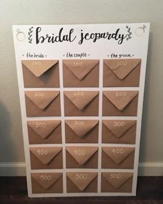 a brown paper bag with the words bridal souvenary written on it, sitting next to a white wall