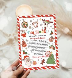 someone is holding up a christmas card with santa's and other holiday related items