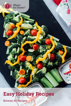 broccoli, carrots and other vegetables on a black platter