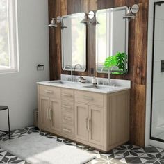 a bathroom with two sinks and mirrors in it