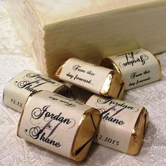 four rolled up wine corks sitting on top of a white table cloth next to a wooden box