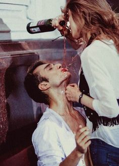 an instagram photo of a man getting his hair cut by a woman who is drinking from a bottle