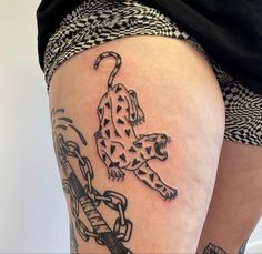 a woman's thigh with a tattoo of a cheetah on the side