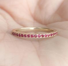 3/4 Eternity Band Ring with Pave Set Natural Ruby MaterialSolid Gold (14K & 18K) FinishHigh Polished/Shiny FitStandard Width1.5 mm Height1.5 mm EdgesMilgrain SettingPave StoneNatural Ruby QualityAAA Cut and ShapeDiamond Cut, Round Total Carat Weightapx 0.30 Click below to add laser engraving. https://www.etsy.com/listing/631070916/laser-engraving?ga_search_query=laser%2Bengraving&ref=shop_items_search_1&frs=1 This ring is full of elegance and beauty! It is so simple and so complete a Classic Ruby Eternity Band For Wedding, Yellow Gold Ruby Eternity Band, Wedding Ruby Eternity Band In Yellow Gold, Wedding Yellow Gold Ruby Eternity Band, Stackable Round Ruby Ring For Wedding, Ruby Eternity Band With Prong Setting For Wedding, Eternity Band With Halo Setting As Gift, Promise Ruby Ring With Half Eternity Band, Promise Ruby Ring With Half Eternity