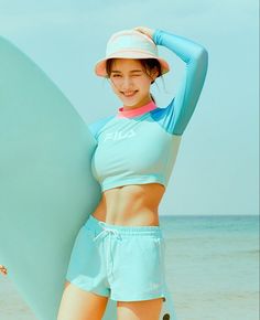 a woman holding a surfboard on the beach