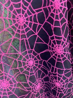 a pink and black fabric with intricate designs