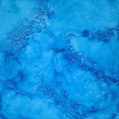 an abstract painting with blue paint and water on the bottom, as well as black ink