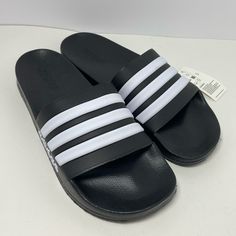 New Men’s Adidas Adilette Shower Slide Sandals Black And White Size 13 Regular Fit Slip-On Construction Synthetic Upper Textile Lining Contoured Footbed Cloudfoam Midsole Synthetic Outsole Black Slip-resistant Slides For Spring, Spring Black Slip-resistant Sandals, Adidas Black Synthetic Sport Sandals, Adidas Non-slip Sandals For Streetwear, Black Adidas Slide Sandals, Casual Black Adidas Flip Flops, Adidas Black Sport Sandals For Summer, Adidas Black Synthetic Flip Flops, Adidas Adilette