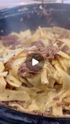 a pot filled with pasta and meat on top of a stove