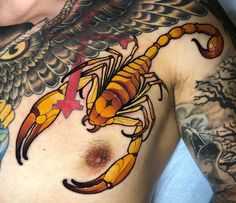 a man with tattoos on his chest has a scorpion tattoo on it's chest