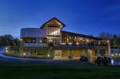 a large building lit up at night with lights on the front and side of it