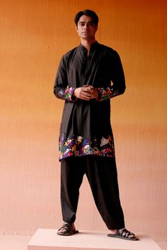 Black silk kurta with figurine motifs, highlighted with bead embroidery on the hem and sleeves. Paired with a pant. - Aza Fashions Traditional Sets With Embroidered Sleeves For Festivals, Traditional Festival Sets With Embroidered Sleeves, Traditional Salwar Kameez With Embroidered Sleeves, Traditional Embroidered Kurta For Navratri, Traditional Navratri Kurta With Embroidered Sleeves, Traditional Sets With Embroidered Sleeves For Transitional Season, Traditional Kurta With Embroidered Sleeves, Cotton Kurta With Embroidered Sleeves For Festivals, Festival Cotton Kurta With Embroidered Sleeves