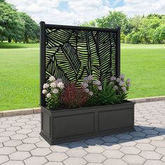 an outdoor planter with plants and flowers in it