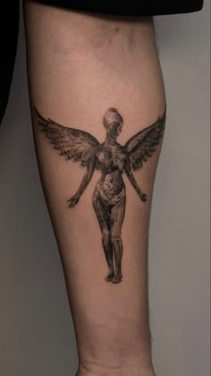 a tattoo on the leg of a woman with an angel above her head and two hands